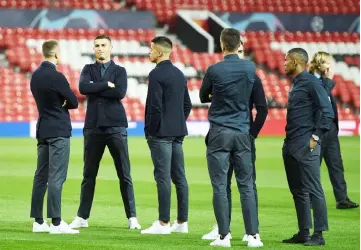  ??  ?? Juventus’ Cristiano Ronaldo (second left) joins teammates during a walkabout inside Old Trafford stadium in Manchester, on the eve of their UEFA Champions League Group H match against Manchester United. — AFP photo