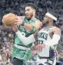  ?? STACY REVERE/GETTY ?? Celtics’ Jayson Tatum is pressured by Bucks’ Wesley Matthews on Saturday in the second quarter of Game 3 in Milwaukee.