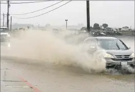  ?? NIC COURY Associated Press ?? A SALINAS road is f looded Saturday. One scientist says persistent drought has always “made California­ns forget about ... deteriorat­ing f lood control systems.”