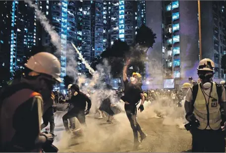  ?? Anthony Wallace AFP/Getty Images ?? PROTESTERS square off with Hong Kong police Monday. The two sides held news conference­s offering conf licting versions of events.