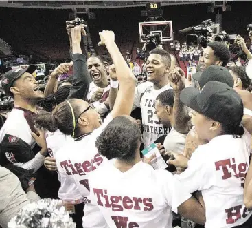  ?? Bob Levey ?? Texas Southern players and followers exhibit their Tiger pride after TSU won the SWAC tournament title Saturday night at Toyota Center. The Tigers eked out a 62-58 victory over Southern.
