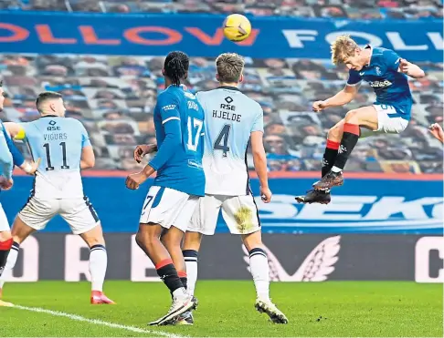  ??  ?? FLYING HIGH: Filip Helander takes to the air to head in Rangers’ second goal in the romp against County.