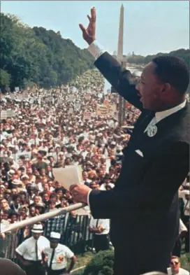  ??  ?? The Reverend Martin Luther King Jr waves to the March on Washington crowd from the steps of the Lincoln Memorial, the site of his ‘I Have a Dream’ speech. Left, George Floyd was arrested in a store after trying to pay for goods using a counterfei­t 20 dollar bill.