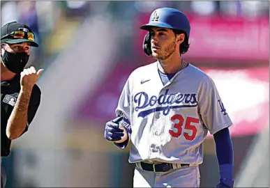  ?? PHOTOS BY DAVID ZALUBOWSKI / AP ?? Los Angeles Dodgers’ Cody Bellinger reacts after being called out after what he thought was a home run in the third inning of a baseball game against the Colorado Rockies Thursday in Denver.