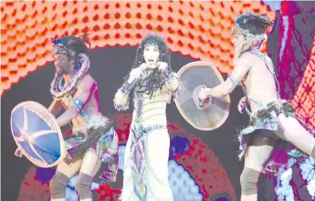  ?? — AFP photo ?? File photo singer Cher (centre) performs with dancers at the MGM Grand Garden Arena during her Dressed to Kill tour on May 25, 2014 in Las Vegas, Nevada.