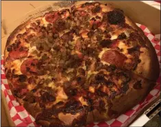  ?? (Arkansas Democrat-Gazette/Eric E. Harrison) ?? Certified Pies’ carnivore-centered Boss Hog pizza — available in 12- and 16inch sizes — comes topped with pepperoni, two kinds of sausage, beef, bacon, a five-cheese blend and red sauce.