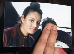  ??  ?? File photo shows Renu Begum holding a photo of her sister Shamima as she makes an appeal for her to return home at Scotland Yard, in London. — Reuters photo