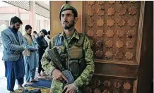  ??  ?? AN AFGHAN security officer stands guard as Muslim devotees offer prayers to start the Eidal-Fitr festival at a mosque in Kabul. | AFP