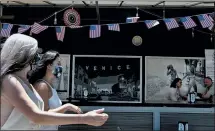  ?? RICHARD VOGEL — THE ASSOCIATED PRESS ?? Pedestrian­s walk past a Venice beach eatery on Friday in Los Angeles. President Trump speaks at Mount Rushmore.