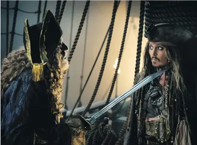  ?? PETER MOUNTAIN / DISNEY VIA THE ASSOCIATED PRESS ?? Geoffrey Rush portrays Barbossa, left, and Johnny Depp is Captain Jack Sparrow in a scene from Pirates of the Caribbean: Dead Men Tell No Tales.