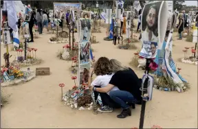  ?? PHOTO: GETTY IMAGES ?? Visitors pay their respect to the victims of October 7 at the Nova Music Festival site six months after the massacre; (inset) Sheryl Sandberg
