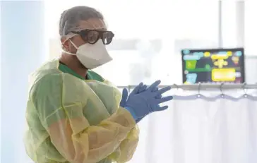  ?? — AFP ?? A nurse checks the vital dates of a patient infected with the novel coronaviru­s Covid-19 in an intensive care unit at the hospital in Freising, southern Germany.