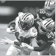  ?? AP/BUTCH DILL ?? New Orleans Saints running back Alvin Kamara (41) carries Sunday against Dallas Cowboys cornerback Chidobe Awuzie (24) and strong safety Jeff Heath (38) in the second half in New Orleans.