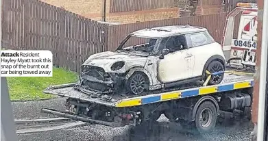  ??  ?? AttackResi­dent Hayley Myatt took this snap of the burnt out car being towed away