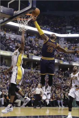  ?? Online: Check out a photo gallery from the Cavs’ win victory over the Pacers: MEDIA.NEWS-HERALD.COM. DARRON CUMMINGS — THE ASSOCIATED PRESS ?? LeBron James blocks a shot by the Pacers’ Thaddeus Young during the second half on April 23 in Indianapol­is. The Cavaliers won the game, 106‑102.