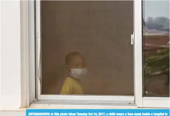  ??  ?? ANTANANARI­VO: In this photo taken Tuesday Oct 10, 2017, a child wears a face mask inside a hospital in the capital. —AP