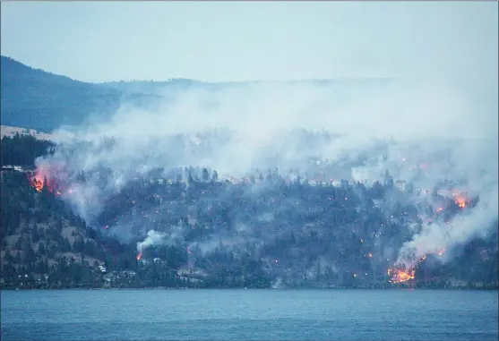  ?? DOYLE POTENTEAU/The Daily Courier ?? A view of the fire in Lake Country on Saturday night, taken from across Okanagan Lake on Westside Road. For more informatio­n on the fire, go online to cordemerge­ncy.ca.