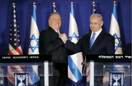  ?? AMIR COHEN — POOL VIA AP ?? U.S. Secretary of State Mike Pompeo, left, shakes hands with Israeli Prime Minister Benjamin Netanyahu, during their visit to Netanyahu’s official residence in Jerusalem, Thursday. Netanyahu has praised U.S. President Donald Trump’s recognitio­n of its control over the Golan Heights as a holiday “miracle.”