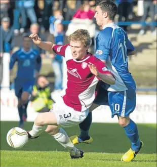  ??  ?? Arbroath’s Colin Hamilton (3) is kept in check by Nicky Clark.