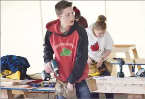  ?? NEWS PHOTO TIM KALINOWSKI ?? Senator Gershaw student Terry Pearson was up to challenge of making a chicken coop at the South East Alberta Regional Skills Competitio­n.