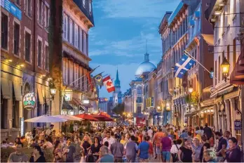  ?? (Stephan Poulin/Tourism Montreal) ?? A busy night on Rue Saint-Paul in Montreal’s Old Town.