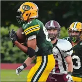  ?? DANA JENSEN/THE DAY ?? New London’s Major Roman intercepts a pass and returns it for a touchdown during the Whalers’ 31-0 win over East Lyme on Friday night.