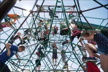  ?? Herald photo by Tijana Martin @TMartinHer­ald ?? Children make their way up the popular Dynamo Meteor during the Pinnacle Park Playground grand opening in Coaldale on Friday.