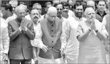  ??  ?? This file photo shows Kovind (left), gesturing as he leaves an NDA meeting with Modi (right) and top Bharatiya Janata Party leader LK Advani (centre) in New Delhi. — AFP photo
