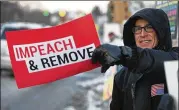  ?? NUCCIO DINUZZO / GETTY IMAGES ?? A protester shows his sentiment Wednesday in Monument Park in Battle Creek, Michigan. The House began hours of debate Wednesday on the two articles of impeachmen­t before the vote in the evening.