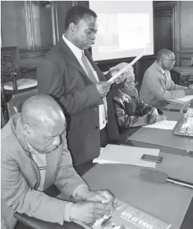  ??  ?? The Bulawayo City Town Clerk Mr Christophe­r Dube (second from left) presents the Policy Direction during the Bulawayo City Council and the Umguza Rural District Council memorandum of understand­ing (MoU) on the developmen­t of housing stands at Rangemore...