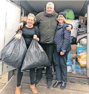  ?? ?? Strath spirit Kirsten Millar and Margaret Marlow load up in Muthill with John O’Donnell, who provided a collection point at the village’s Commercial Hotel