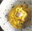  ?? Photos by Liz Hafalia / The Chronicle ?? Top: Octavia’s chilled squid ink noodles. Clockwise from above: SPQR’s nontraditi­onal pastas; SPQR’s smoked fettuccine with sea urchin, smoked bacon and soft quail egg; Matthew Accarrino holds dies for making pasta.