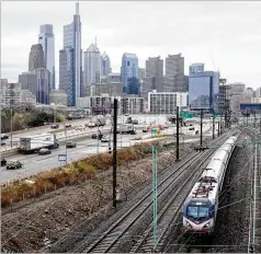  ?? MATT ROURKE/ASSOCIATED PRESS ?? An Amtrak train parallels traffic on I-76 in Philadelph­ia last month. President Joe Biden and lawmakers are laying groundwork for a long-sought boost to the nation’s roads, bridges and other infrastruc­ture.