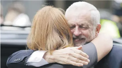  ?? Picture: AFP ?? VICTORY HUG. Britain’s opposition Labour Party leader Jeremy Corbyn embraces a member of his team, Karie Murphy, as he arrives at Labour Party headquarte­rs in central London yesterday after results in a snap general election showing a hung parliament...