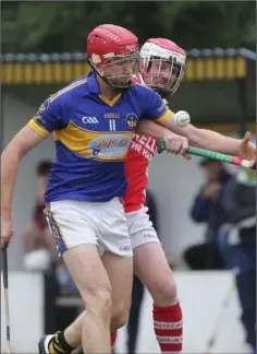  ??  ?? Robert Butler of St. Mary’s (Rosslare) battles for the ball with Paddy Breen (Monageer-Boolavogue).