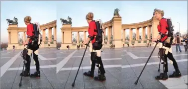  ??  ?? Amanda Boxtel walks in the world’s first 3D printed hybrid robotic exoskeleto­n suit