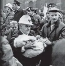  ??  ?? Horror: An ambulancem­an carries the body of 17-month-old Colin Nicholl from the scene of a no-warning IRA explosion at a furniture showroom on the Shankill Road in 1971
