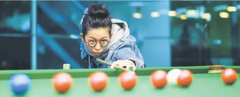  ?? — AFP photo ?? Women’s snooker world champion Ng On-yee of Hong Kong takes a shot for a training during an interview with AFP at a snooker club in Hong Kong.