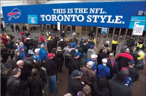  ?? ?? The Associated Press
Fans enter the Rogers Centre before the Buffalo Bills play the Atlanta Falcons in NFL action in Toronto, on Dec. 1, 2013.