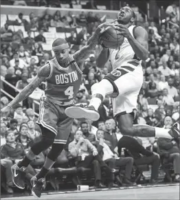  ?? Photo by Jonathan Newton / The Washington Post ?? Washington point guard John Wall (2), seen here driving past Isaiah Thomas (4), is averaging 29 points and 11 assists in the playoffs.