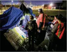  ?? JASON GETZ/AJC FILE ?? Volunteers and staffers take part in a “point in time” count, a practice mandated by the federal government that tallies people homeless on one night in January each year. A bill proposed last year would have made camping on public property a misdemeano­r.