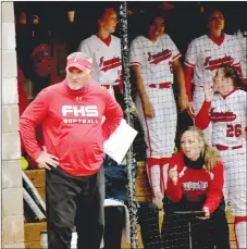  ?? MARK HUMPHREY ENTERPRISE-LEADER ?? Farmington softball coach Randy Osnes assesses a game situation by stepping out of the dugout. The veteran coach will retire after the season after compiling a Hall-of-Fame type career with at least three state championsh­ips and well over 500 wins.