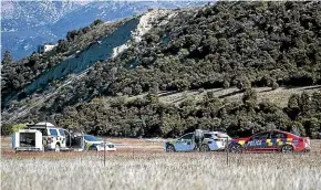  ?? GEORGE HEARD/STUFF ?? Police at the site of the helicopter crash in Wanaka last week in which three people died.