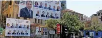  ?? - Reuters ?? CONTENDERS: Posters with Lebanese parliament candidates are seen on a building in Beirut, Lebanon April 23, 2018.