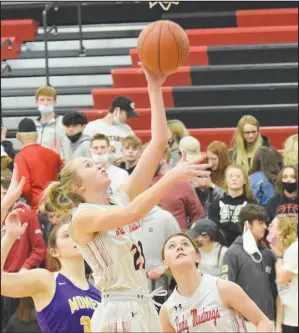  ?? RICK PECK/SPECIAL TO MCDONALD COUNTY PRESS ?? McDonald County’s Kristen Penn makes a left-handed layup as teammate Sydney Killion looks on during the Lady Mustangs 57-15 win over Monett in the opening round of the Missouri Class 5 District 11 Girls Basketball Tournament held on March 2 at MCHS.