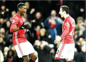  ?? OLI SCARFF/AFP ?? Manchester United’s Paul Pogba (left) and Henrikh Mkhitaryan celebrate a goal in their English Premier League match against Sunderland on December 26.