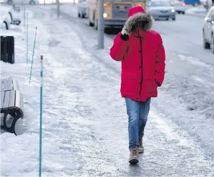  ?? ALLEN McINNIS ?? A pedestrian navigates Peel St. in Montreal on Wednesday. Urgences Santé has reported a spike in the number of calls due to falls.