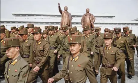  ?? ED JONES/AFP ?? Korean People’s Army (KPA) soldiers leave after paying their respects before the statues of late North Korean leaders Kim Il-sung and Kim Jong-il at Mansu hill in Pyongyang on April 15.