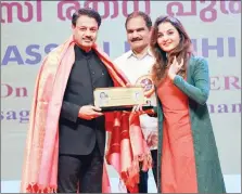  ?? ?? Pravasi Ratna Award winner Dr. Hassan Kunhi M.P with K. Govindan, chairman of KCCL, and Malayalam film actress Manju Warrier.