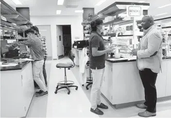  ?? NELVIN C. CEPEDA U-T PHOTOS ?? CEO Paul Mola (right) talks with principal scientist Venkatesh A. Govindaraj at Roswell Biotechnol­ogies in Sorrento Valley. He said he's often felt like he had to work twice as hard as his White colleagues to get noticed.